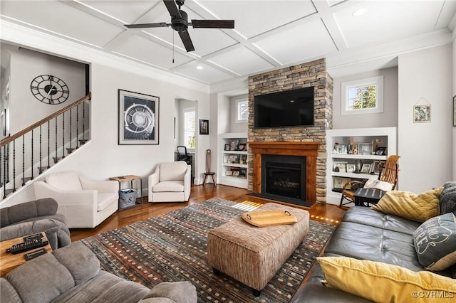 living area featuring a healthy amount of sunlight, coffered ceiling, and wood finished floors