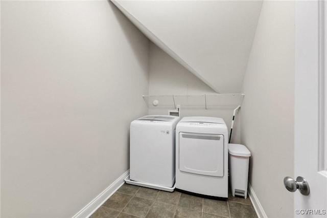 washroom with laundry area, baseboards, and washer and clothes dryer