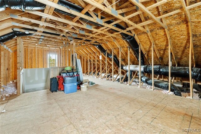 unfinished attic with an upstairs landing