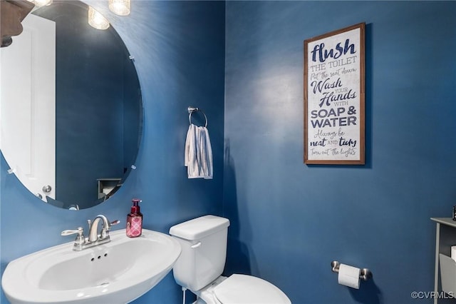 bathroom featuring toilet and a sink