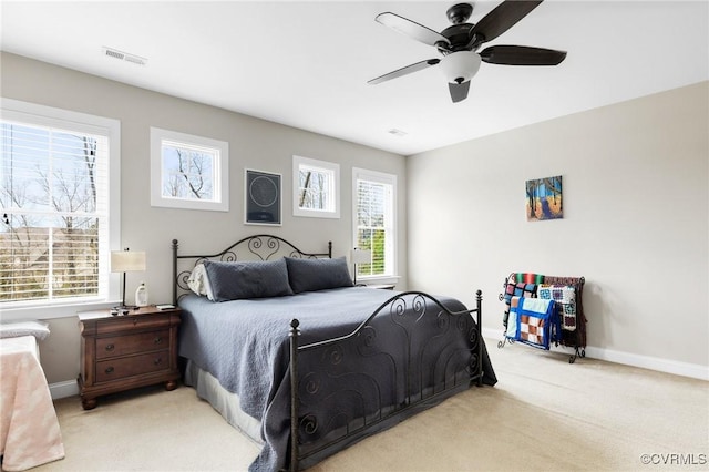 bedroom with visible vents, carpet floors, baseboards, and ceiling fan