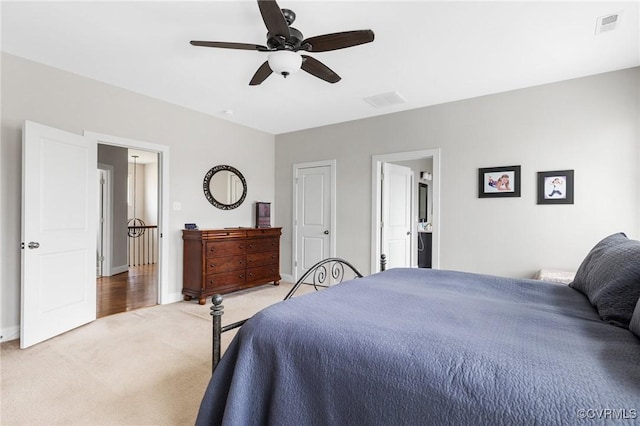 bedroom with a ceiling fan, baseboards, visible vents, and light carpet