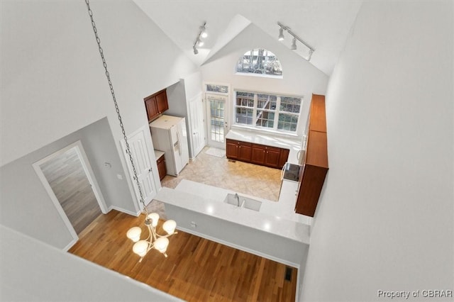 living room with high vaulted ceiling and track lighting