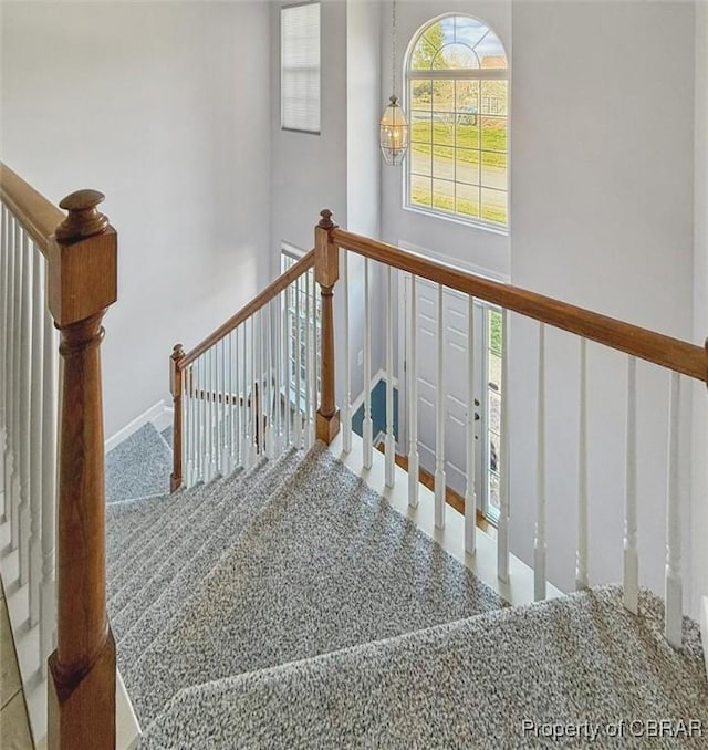 stairs featuring a high ceiling