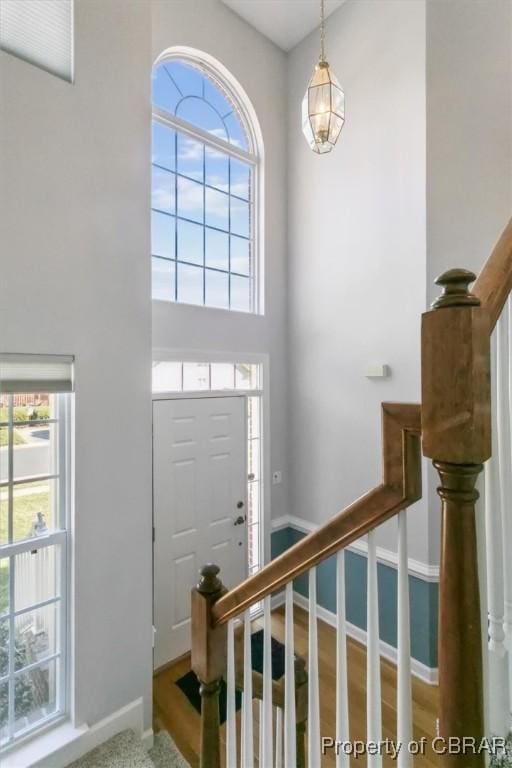 entryway with stairway, baseboards, and a healthy amount of sunlight