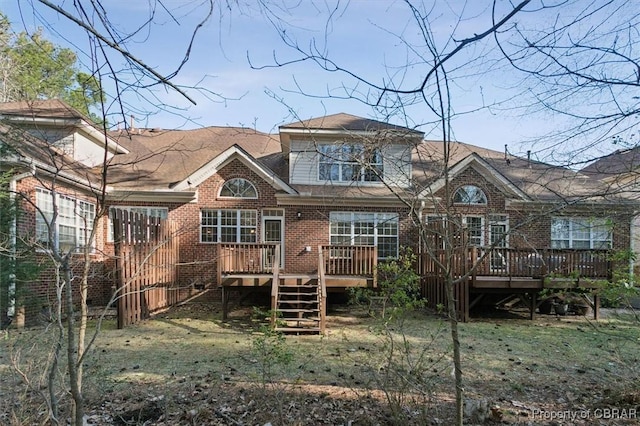 back of house with brick siding, stairway, and a wooden deck