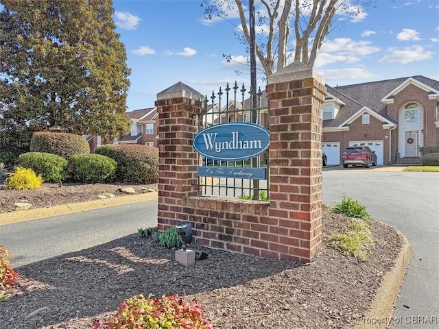 community / neighborhood sign featuring a garage