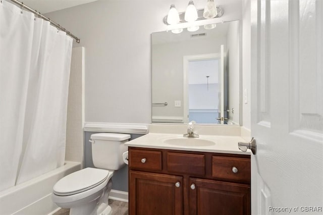 bathroom with vanity, shower / bath combo with shower curtain, toilet, and visible vents