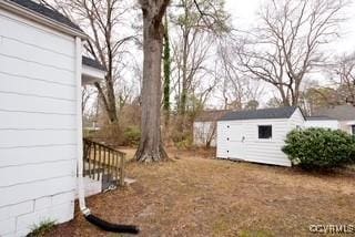 view of yard with an outdoor structure and a shed