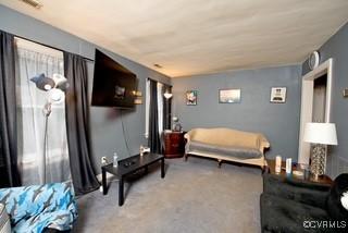 living area featuring carpet and visible vents