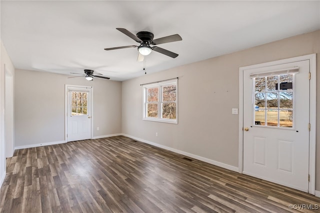 entryway featuring baseboards, plenty of natural light, and wood finished floors