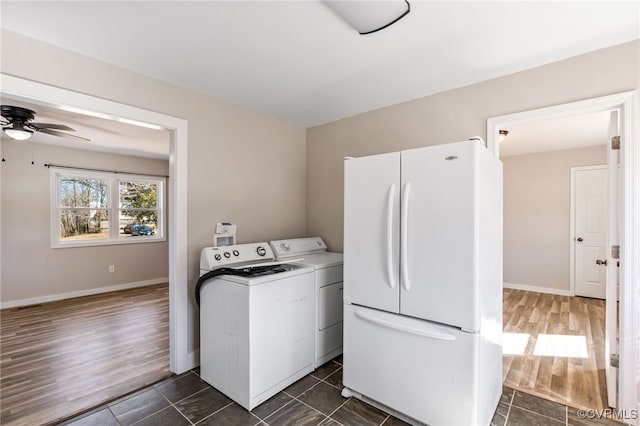 laundry area with dark wood-type flooring, separate washer and dryer, baseboards, ceiling fan, and laundry area