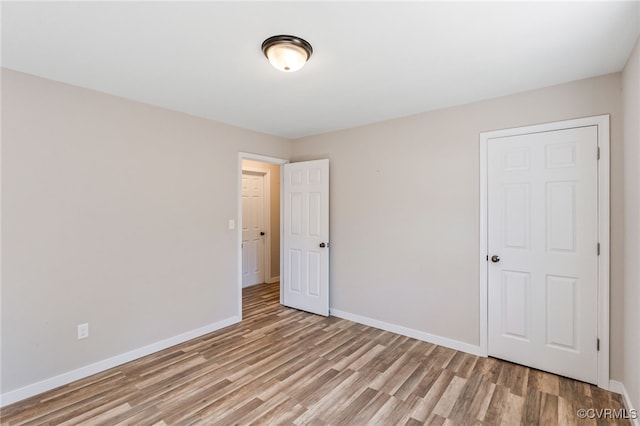 unfurnished bedroom featuring baseboards and light wood-style flooring