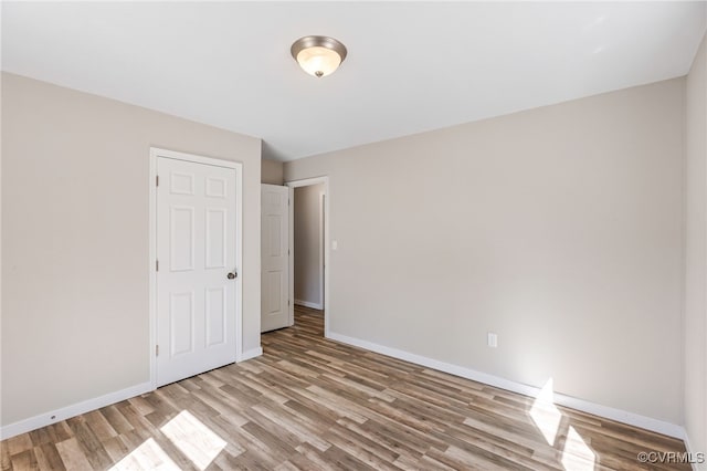 unfurnished bedroom featuring baseboards and light wood finished floors