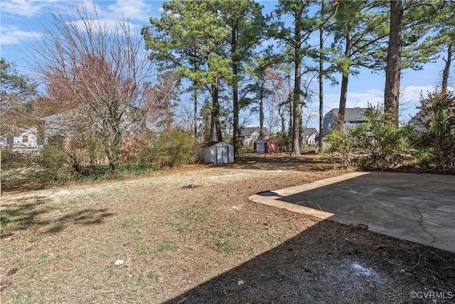 view of yard featuring an outbuilding and a storage shed