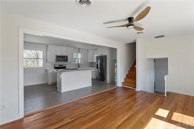 kitchen featuring light countertops, wood finished floors, visible vents, and stainless steel appliances