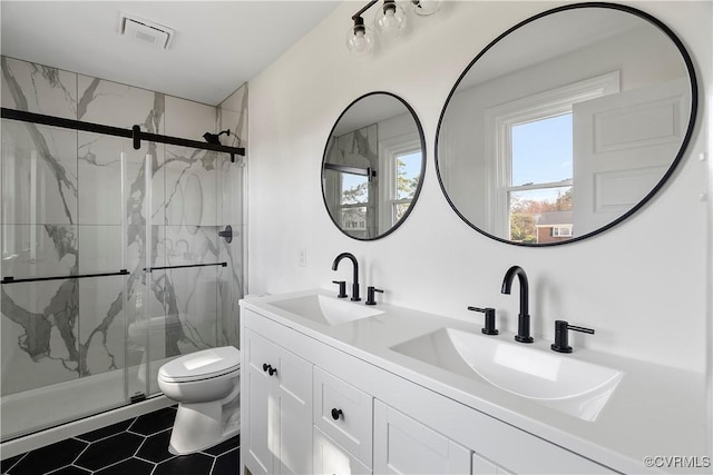 full bathroom with a sink, visible vents, toilet, and a marble finish shower