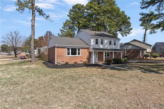 traditional-style house featuring a front lawn, brick siding, and crawl space