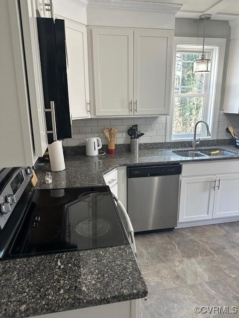 kitchen featuring a sink, tasteful backsplash, white cabinetry, and stainless steel appliances