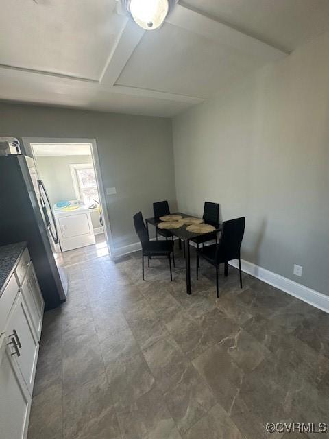 dining area featuring washer / clothes dryer and baseboards