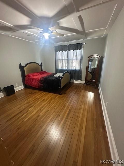 bedroom featuring coffered ceiling, baseboards, and wood-type flooring