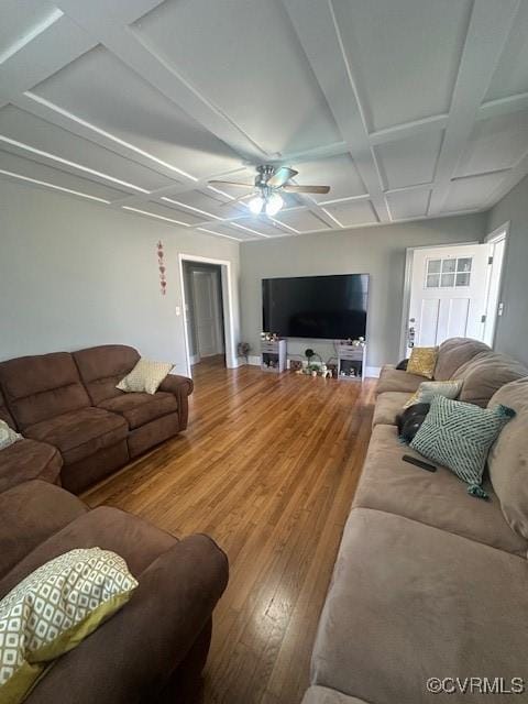 living room with beam ceiling, coffered ceiling, wood finished floors, and a ceiling fan