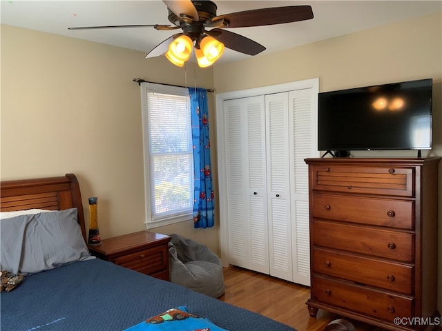 bedroom with a closet, ceiling fan, and wood finished floors