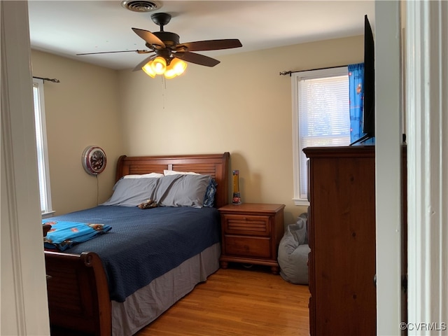 bedroom featuring light wood-style flooring and ceiling fan