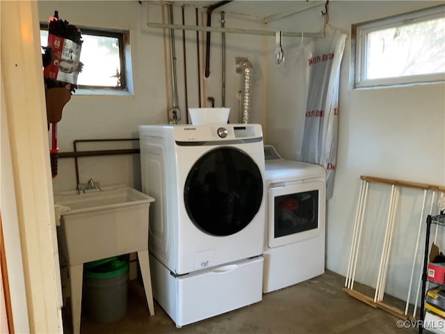 washroom with a wealth of natural light, independent washer and dryer, and laundry area