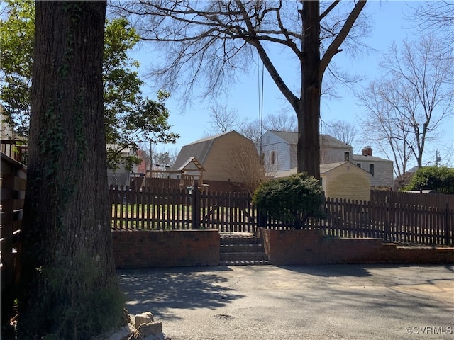 view of gate with a fenced front yard