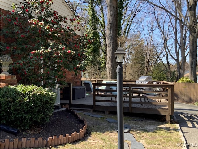 view of yard with a deck and fence