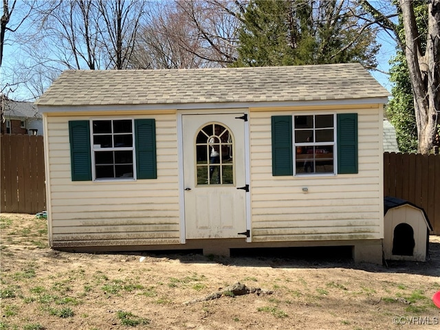 view of outbuilding with an outdoor structure and fence