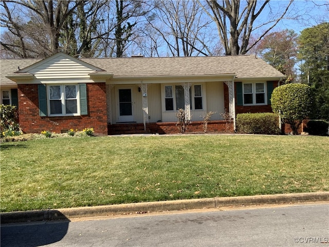 single story home with brick siding, roof with shingles, and a front yard