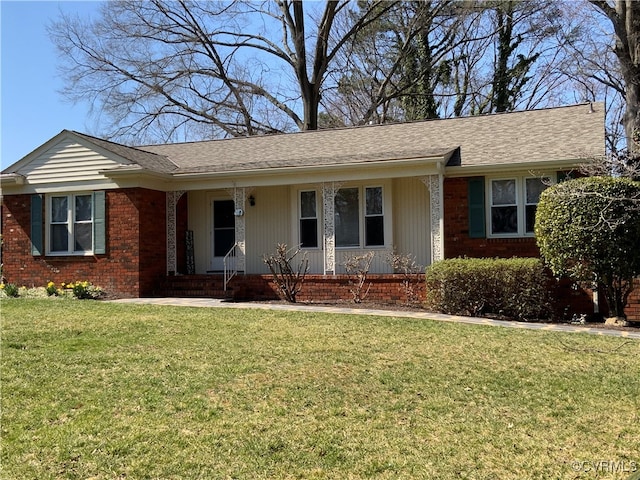 ranch-style home with a front yard, brick siding, and a shingled roof