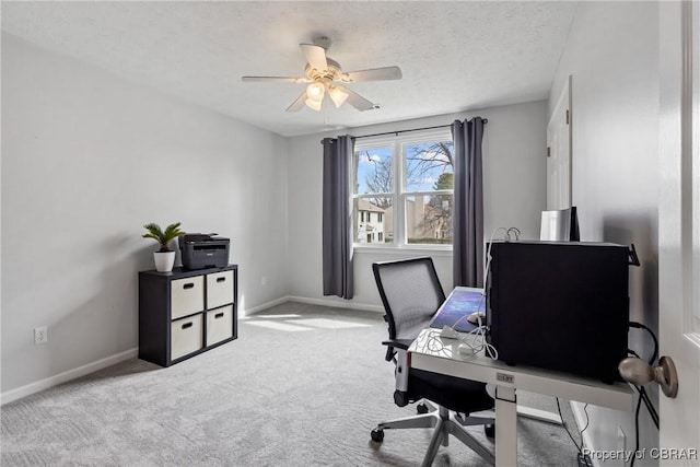 home office with ceiling fan, carpet, baseboards, and a textured ceiling