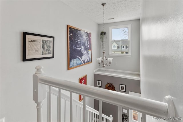 interior space with an inviting chandelier and a textured ceiling