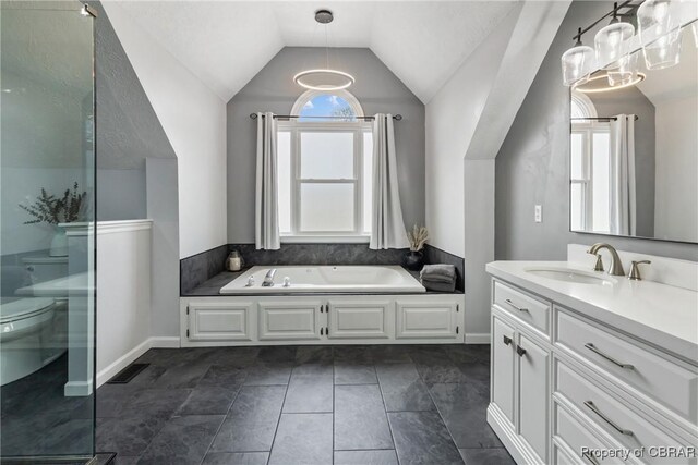 full bathroom with a healthy amount of sunlight, a garden tub, vanity, and lofted ceiling