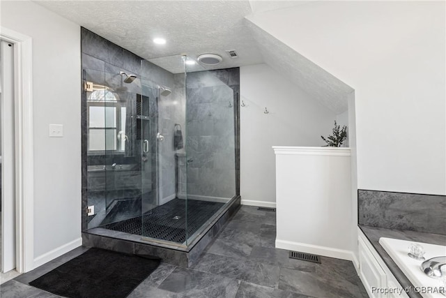 full bathroom with visible vents, a textured ceiling, a shower stall, lofted ceiling, and a bath