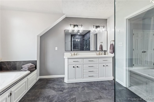 full bathroom featuring a sink, a textured ceiling, double vanity, walk in shower, and a bath