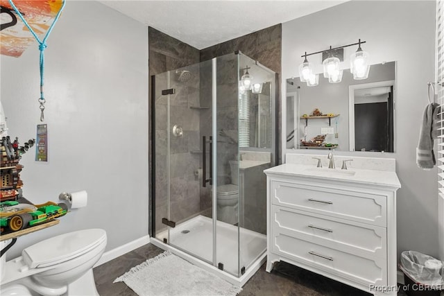 full bathroom featuring a shower stall, toilet, vanity, and baseboards