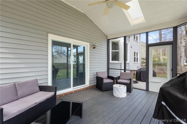 wooden deck featuring grilling area, outdoor lounge area, and a ceiling fan