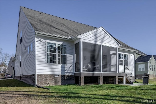 rear view of house with stairway, a yard, a sunroom, and crawl space