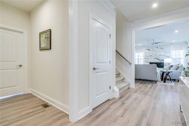 hall with visible vents, light wood-style flooring, recessed lighting, baseboards, and stairs