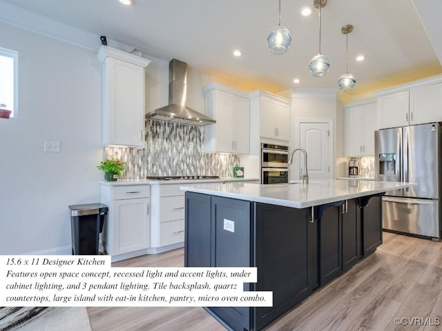 kitchen featuring stainless steel appliances, light countertops, white cabinets, wall chimney exhaust hood, and backsplash