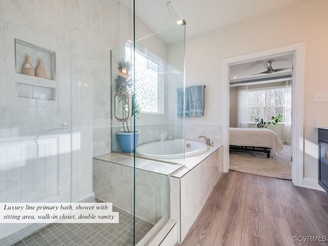 bathroom with connected bathroom, a garden tub, and wood finished floors