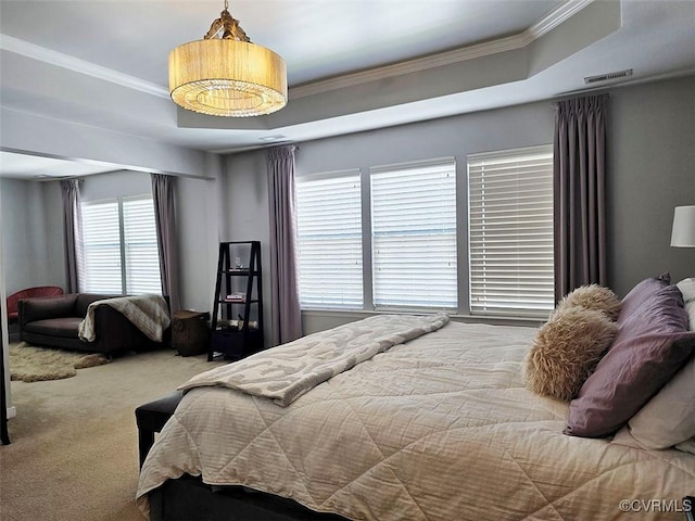 carpeted bedroom with a raised ceiling, crown molding, and visible vents