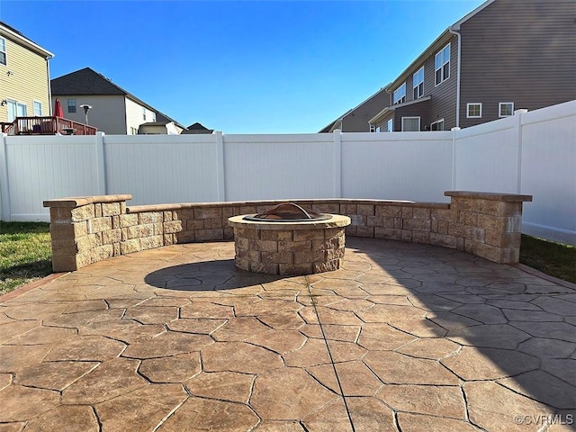 view of patio / terrace featuring an outdoor fire pit and a fenced backyard