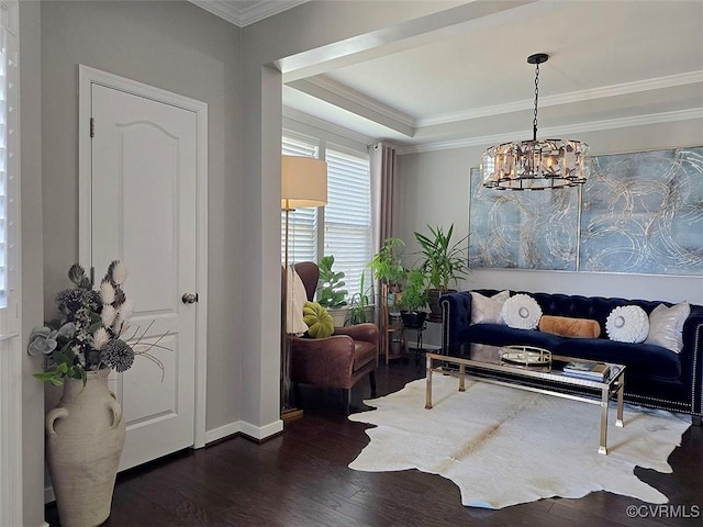 interior space featuring a tray ceiling, a notable chandelier, dark wood-type flooring, and crown molding