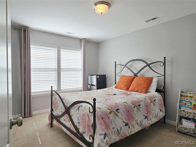 bedroom with carpet flooring, baseboards, and visible vents