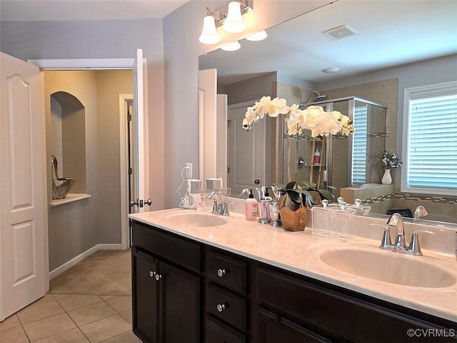 full bathroom featuring a sink, visible vents, a stall shower, and tile patterned flooring